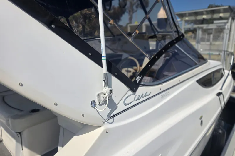 Slide: The Image of 2000 Bayliner 2855 Ciera boat with sleek white exterior and clear windshield. - 6