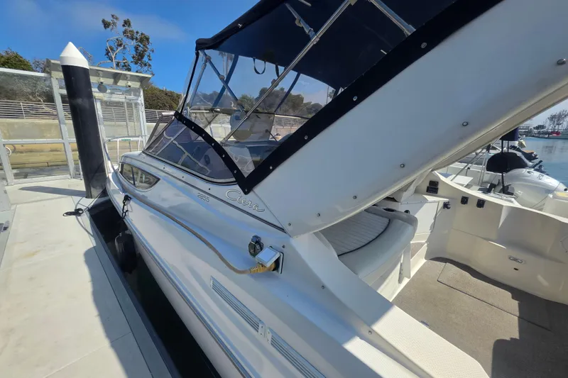 Slide: The Image of 2000 Bayliner 2855 Ciera boat docked at marina, featuring sleek design and canopy. - 7