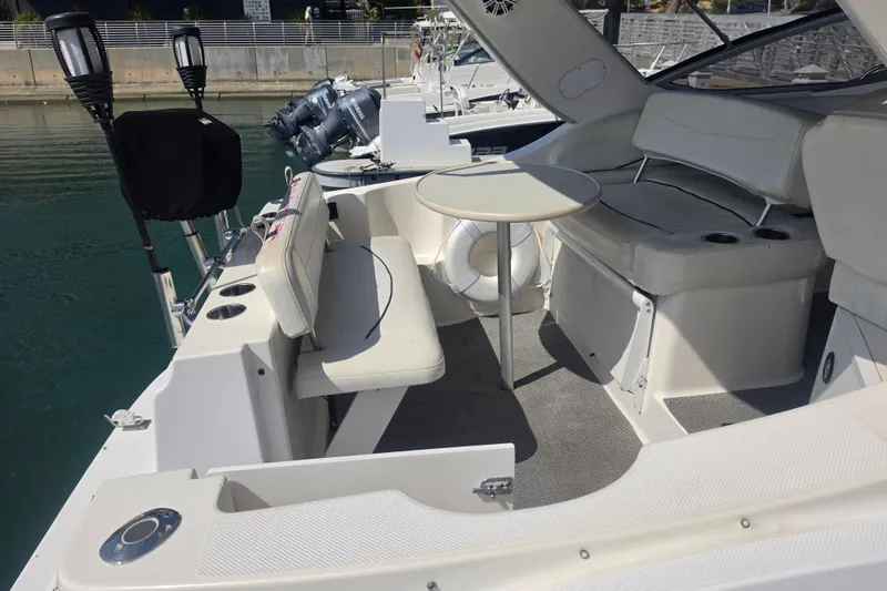 Slide: The Image of 2000 Bayliner 2855 Ciera boat interior with seating and table, docked at marina. - 9
