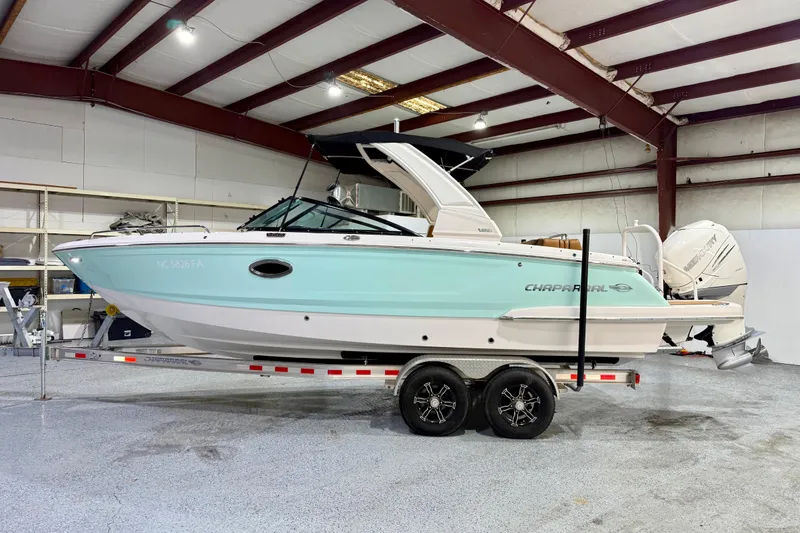 The Image of 2023 Chaparral 270 OSX boat on trailer in indoor storage facility. - 1