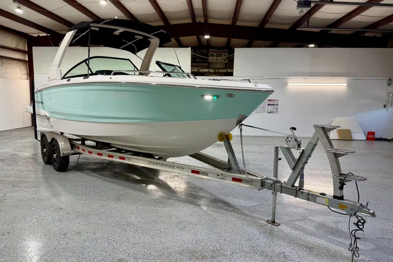 Slide: The Image of 2023 Chaparral 270 OSX boat on trailer in indoor storage facility. - 11