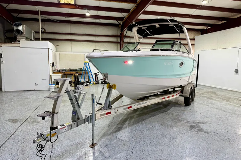 Slide: The Image of 2023 Chaparral 270 OSX boat on trailer in indoor storage facility. - 13