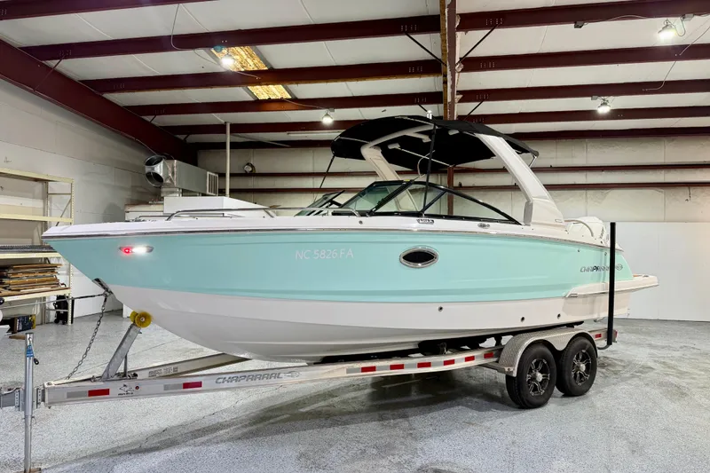 Slide: The Image of 2023 Chaparral 270 OSX boat on trailer in indoor storage facility. - 14