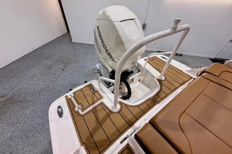 Slide: The Image of 2023 Chaparral 270 OSX boat with Mercury outboard engine and teak-style deck. - 15