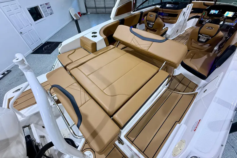 Slide: The Image of 2023 Chaparral 270 OSX boat interior with tan leather seating and modern dashboard. - 18