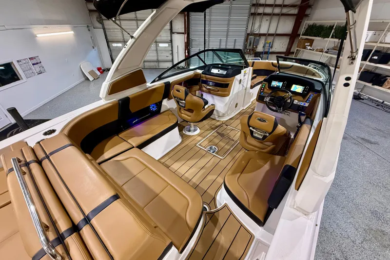 Slide: The Image of Interior view of 2023 Chaparral 270 OSX boat with luxurious seating and modern dashboard. - 19