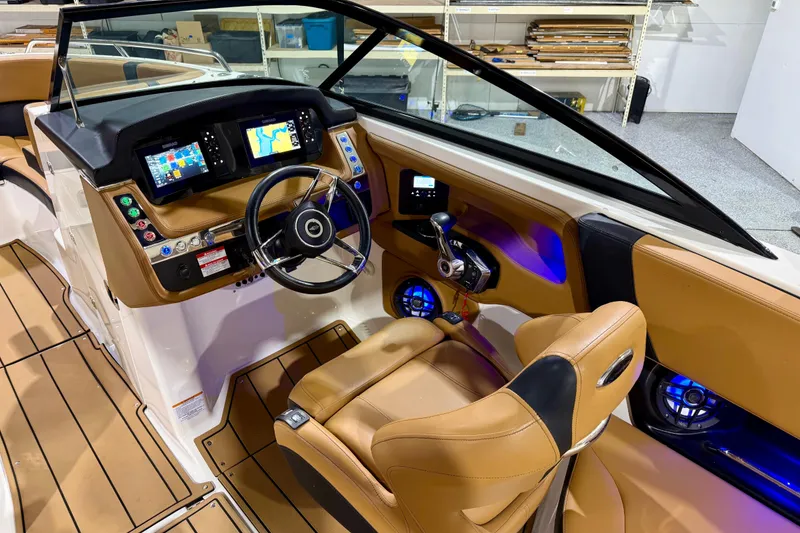 Slide: The Image of 2023 Chaparral 270 OSX boat cockpit with modern controls and navigation displays. - 26