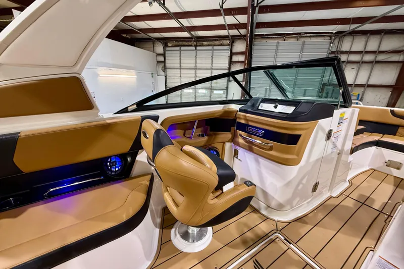 Slide: The Image of Interior of 2023 Chaparral 270 OSX boat with tan and black seating. - 28