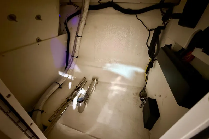 Slide: The Image of 2023 Chaparral 270 OSX interior storage compartment with wiring and equipment. - 36