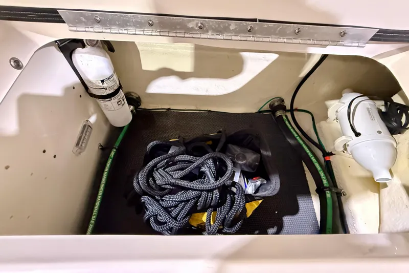 Slide: The Image of Storage compartment of 2023 Chaparral 270 OSX boat with ropes and equipment. - 37