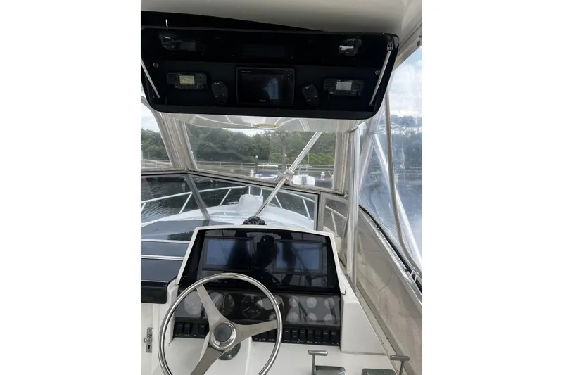 Slide: The Image of Cockpit view of 1993 Blackfin 31 Combi boat with steering wheel and navigation equipment. - 4