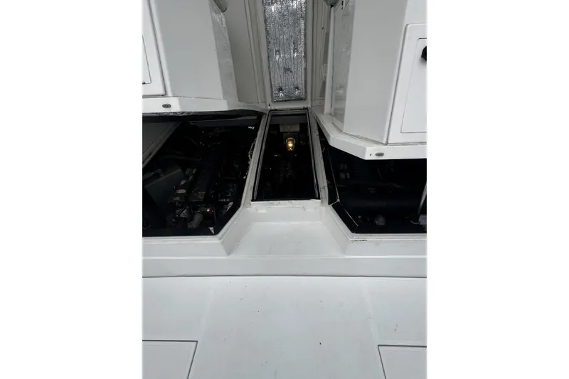 Slide: The Image of Engine compartment of a 1993 Blackfin 31 Combi boat, showcasing mechanical details. - 5