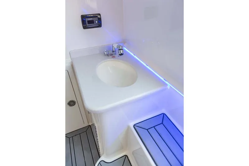 Slide: The Image of Manufacturer Provided Image: 2020 Cobia 350 Center Console boat interior sink and counter area with blue LED lighting. - 21