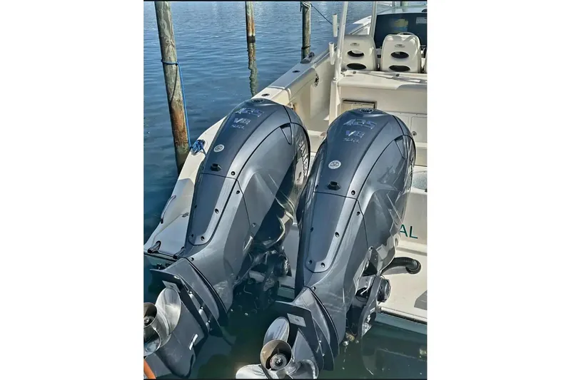 Slide: The Image of 2020 Cobia 350 Center Console with twin outboard engines docked. - 24