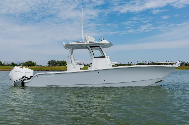 The Image of 2023 Freeman 28 boat on calm water under a blue sky. - 1