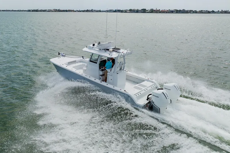 Slide: The Image of 2023 Freeman 28 boat cruising on open water with twin Mercury engines. - 10