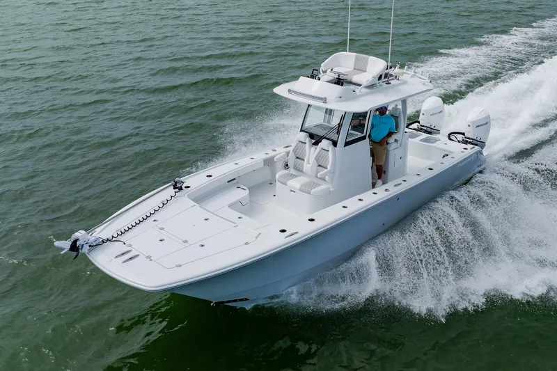 Slide: The Image of 2023 Freeman 28 boat cruising on open water with dual engines. - 11