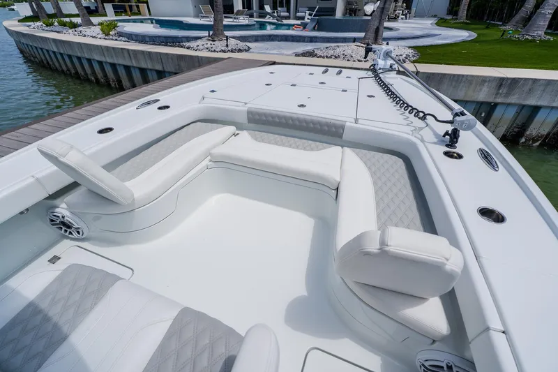 Slide: The Image of Luxurious seating area on a 2023 Freeman 28 boat, docked by a waterfront. - 12