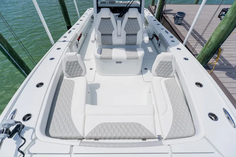 Slide: The Image of Luxurious 2023 Freeman 28 boat interior with diamond-stitched seating, docked by the water. - 21