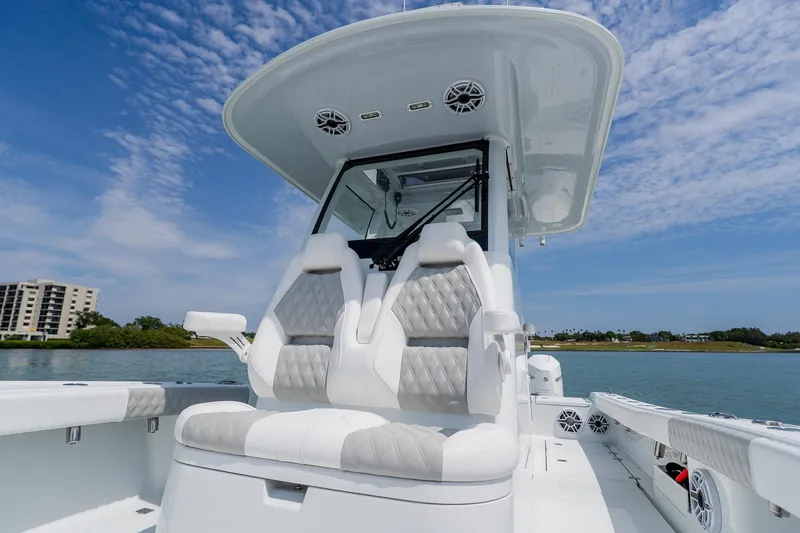 Slide: The Image of 2023 Freeman 28 boat with luxurious seating, sleek design, and scenic waterfront view. - 22