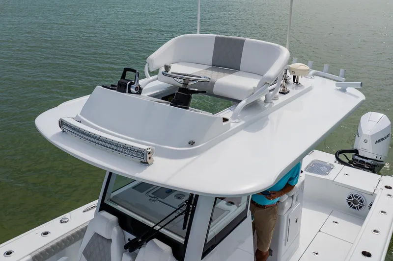 Slide: The Image of 2023 Freeman 28 boat with elevated helm station on calm water. - 25