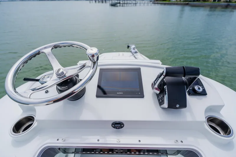 Slide: The Image of Helm of 2023 Freeman 28 boat with steering wheel and navigation controls. - 26
