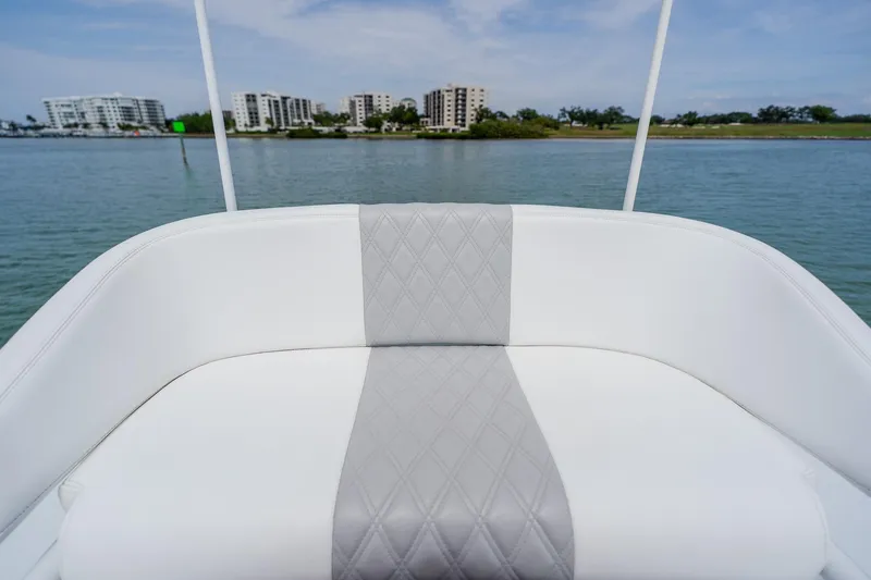Slide: The Image of Luxurious seating on a 2023 Freeman 28 boat with waterfront cityscape view. - 27
