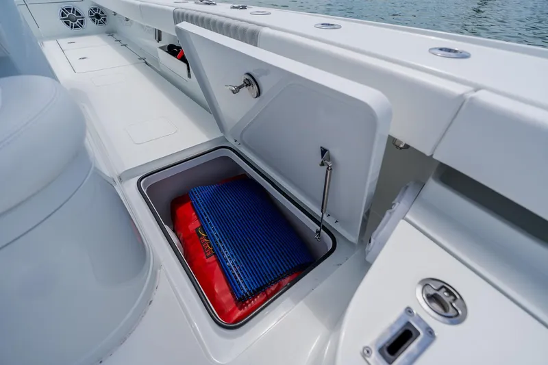 Slide: The Image of Open storage compartment on a 2023 Freeman 28 boat, featuring marine equipment. - 28