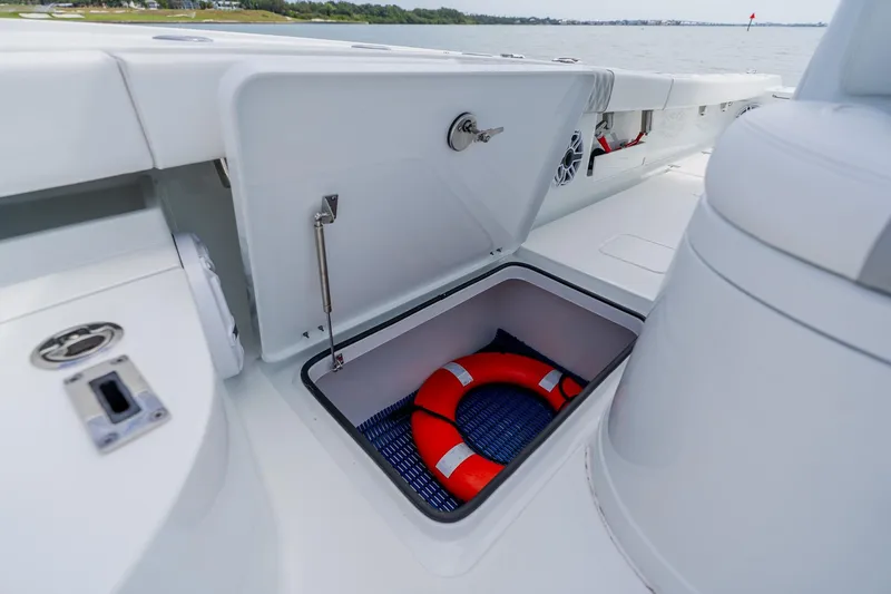 Slide: The Image of Storage compartment on 2023 Freeman 28 boat with life preserver inside. - 29