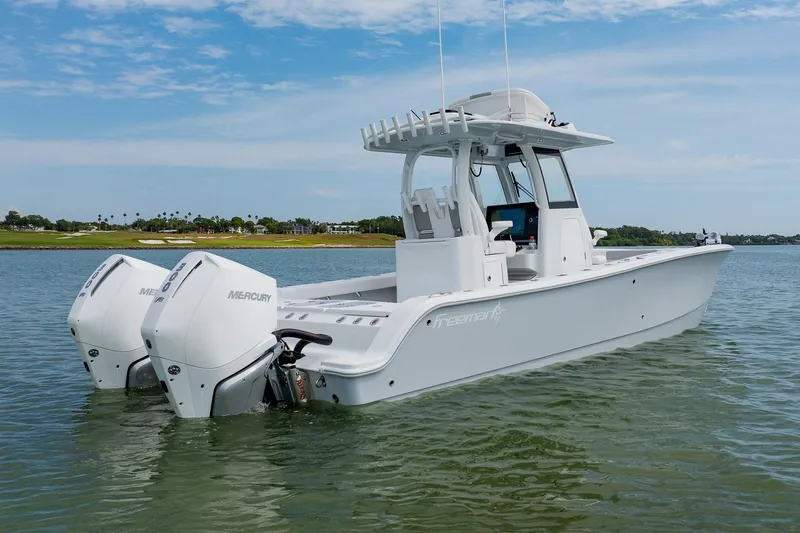 Slide: The Image of 2023 Freeman 28 boat with twin Mercury engines on calm water. - 3