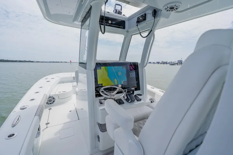Slide: The Image of 2023 Freeman 28 boat interior with advanced navigation system on calm waters. - 30