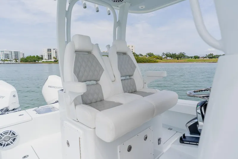 Slide: The Image of Luxury seating on a 2023 Freeman 28 boat, featuring dual cushioned seats and scenic waterfront view. - 33