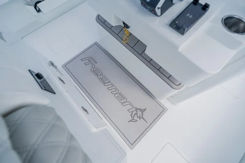 Slide: The Image of Interior of 2023 Freeman 28 boat featuring branded mat and control panel. - 35