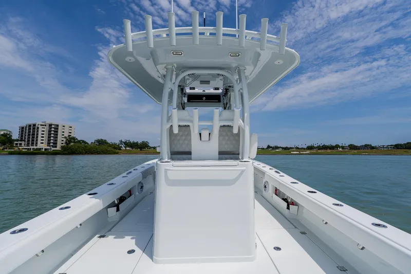 Slide: The Image of 2023 Freeman 28 boat on water, featuring sleek design and spacious deck under blue sky. - 36