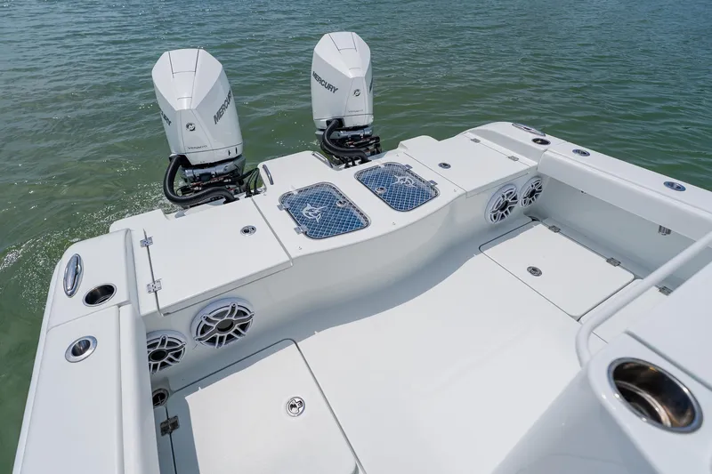 Slide: The Image of 2023 Freeman 28 boat with dual Mercury engines on calm water. - 39