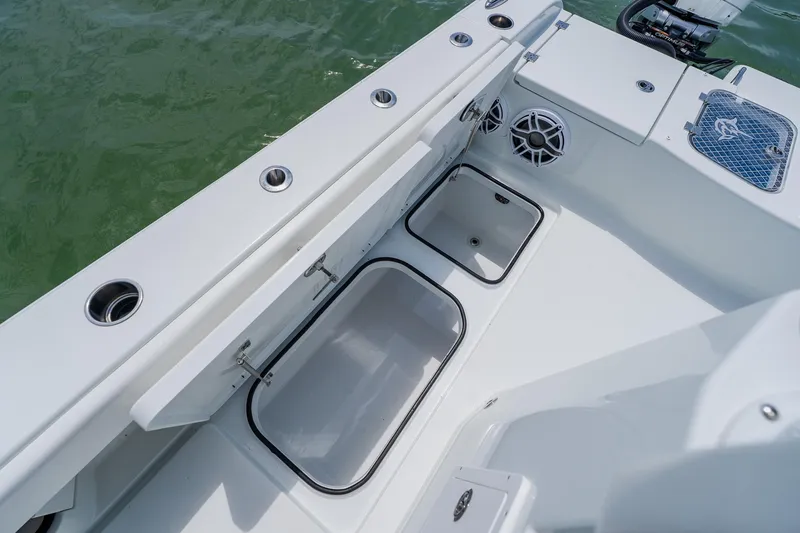 Slide: The Image of 2023 Freeman 28 boat interior with open storage compartments and speaker system. - 43