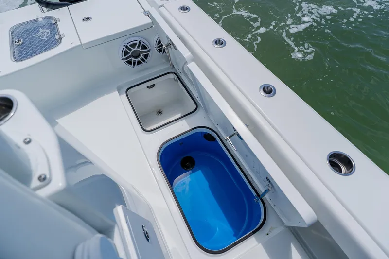 Slide: The Image of 2023 Freeman 28 boat interior with storage compartments and speakers on deck. - 44