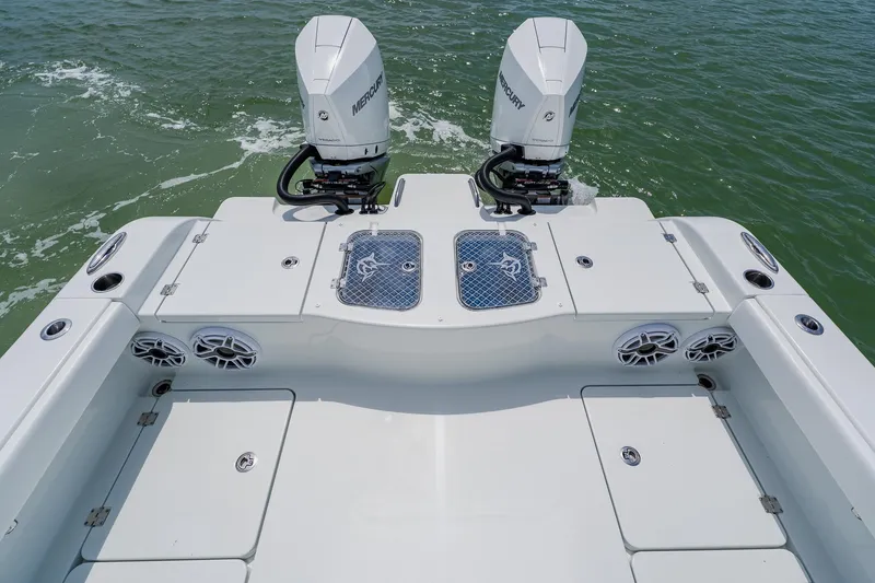 Slide: The Image of Freeman 28 boat deck with dual Mercury engines, 2023 model, on calm water. - 45