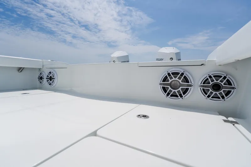 Slide: The Image of 2023 Freeman 28 boat deck with speakers under a clear blue sky. - 46