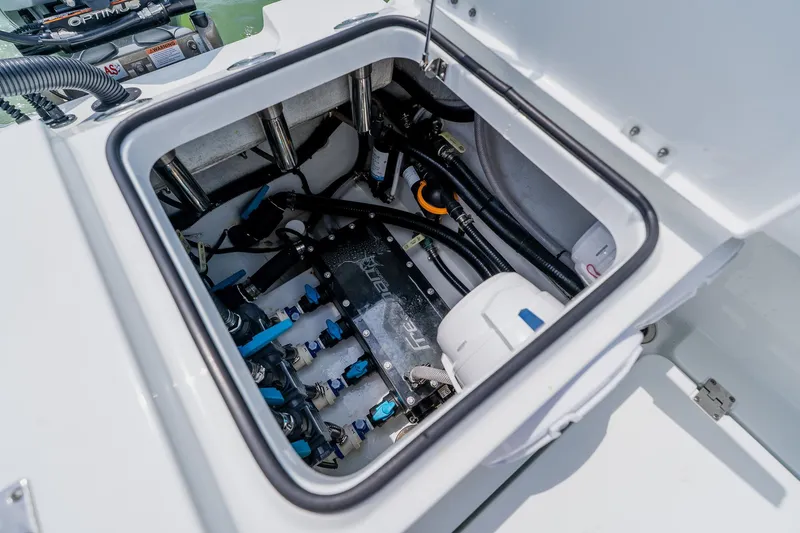 Slide: The Image of Engine compartment of a 2023 Freeman 28 boat, showcasing intricate mechanical components. - 49