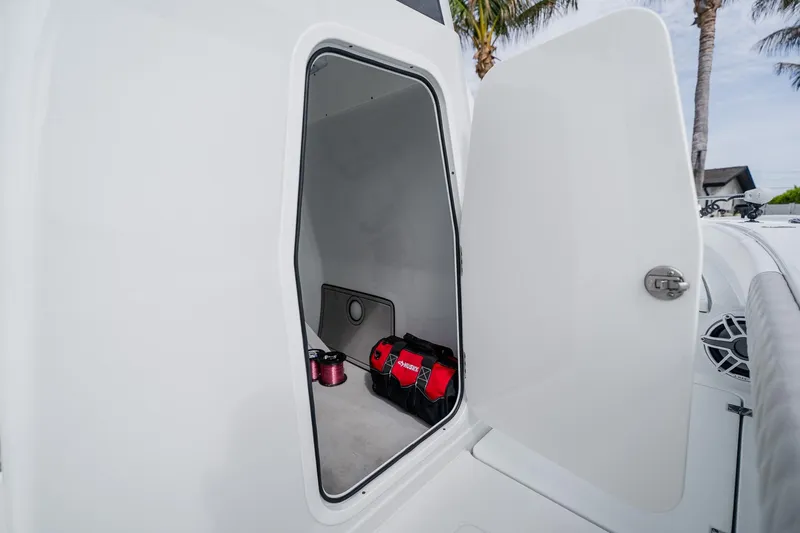 Slide: The Image of Open storage compartment on 2023 Freeman 28 boat, featuring organized interior space. - 50
