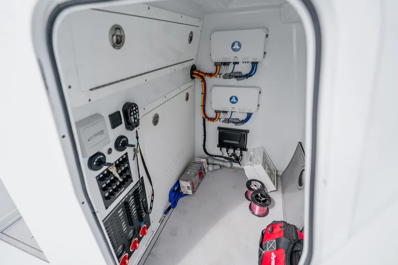 Slide: The Image of Electrical compartment of 2023 Freeman 28 boat with wiring and control panels. - 51