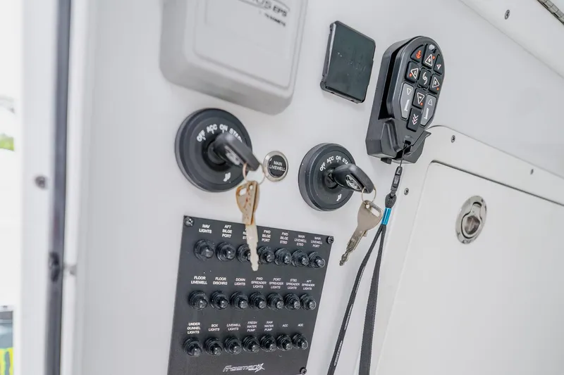 Slide: The Image of Control panel of a 2023 Freeman 28 boat with switches and keys. - 52