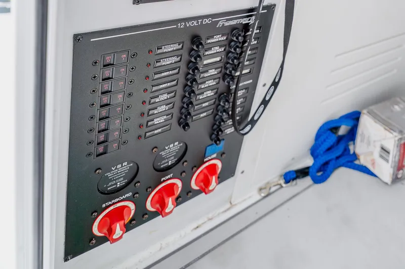 Slide: The Image of Electrical control panel on a 2023 Freeman 28 boat, featuring switches and wiring. - 53