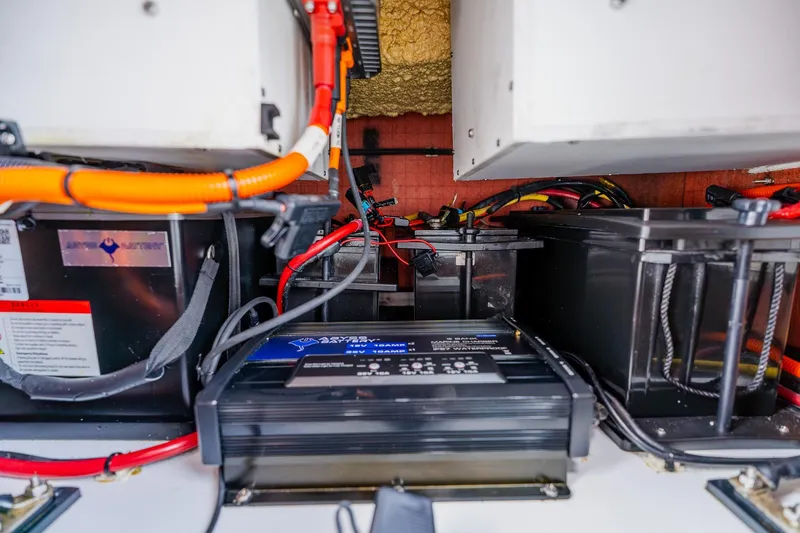 Slide: The Image of Electrical system setup in a 2023 Freeman 28 boat, featuring batteries and wiring. - 54