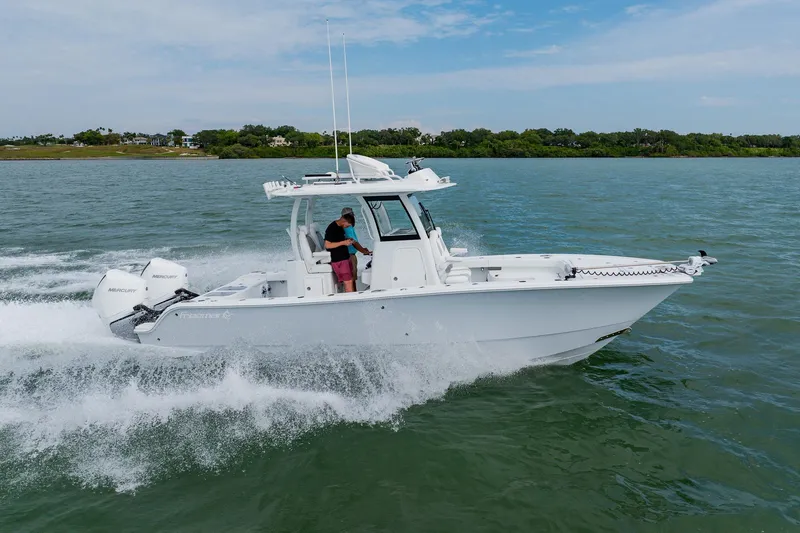Slide: The Image of 2023 Freeman 28 boat cruising on water with two Mercury engines. - 9
