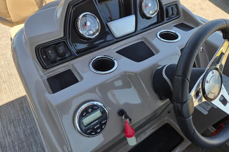 Slide: The Image of 2023 Ranger Reata 200F boat dashboard with steering wheel, gauges, and controls. - 10