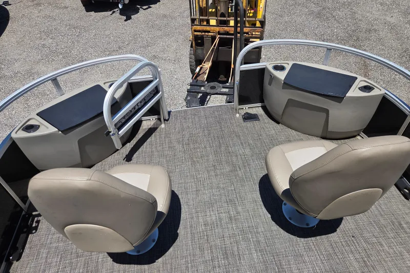Slide: The Image of 2023 Ranger Reata 200F boat interior with two beige seats and storage compartments. - 11