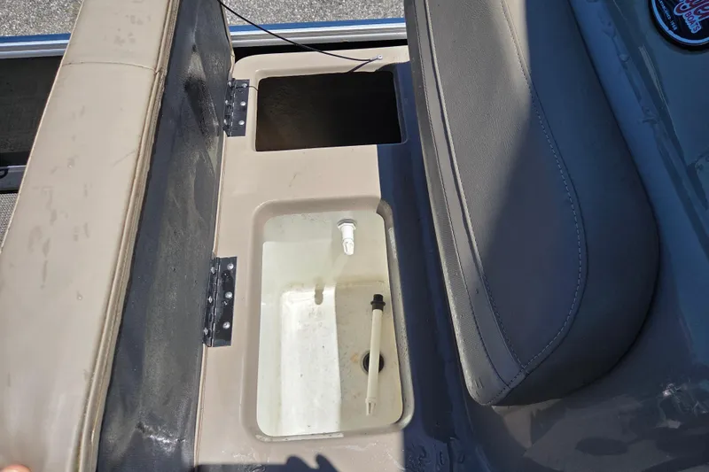 Slide: The Image of 2023 Ranger Reata 200F boat seat storage compartment with open lid and visible interior. - 12