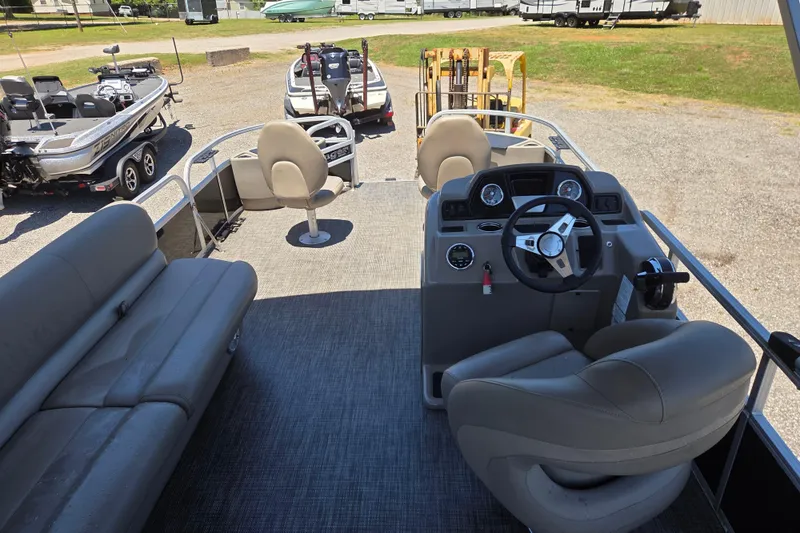 Slide: The Image of 2023 Ranger Reata 200F pontoon boat interior with steering console and seating. - 13